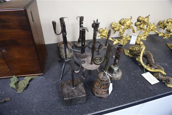 Eleven 17th century and later iron rushlight holders and candlesticks, largest 11.5in.